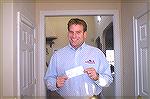 Jim Barnes,owner of Signature Alert Home & Business Security Systems, shows his first check when he opened his Eastern Shore Franchise several years ago.  