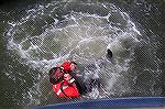 A member of the Coast Guard demonstrates how a survival suit works at Harbor Day in W. Ocean City.