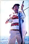 Joe Reynolds holds up a 13-pound bluefish caught off Ocean City on a popping bug.