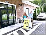 Joe Reynolds and Esther Diller place Goose Crossing sign at entrance to Country Club to protect area goose population.