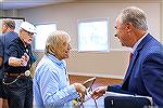 From left to right - Association member Roelof "Dutch" Oostveen, Ocean Pines Progress publisher Tom Stauss, and OPA General Manager John Viola chat after the 2024 OPA Annual Meeting of the Membership 